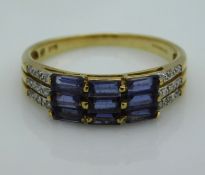A 9ct gold ring set with small diamonds & blue paste stones, 2.6g, size R/S