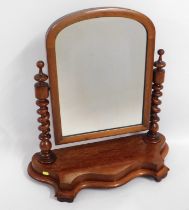 A Victorian walnut dressing table mirror with barl