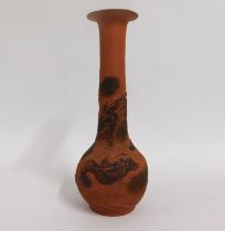 A Japanese terracotta vase decorated in relief wit