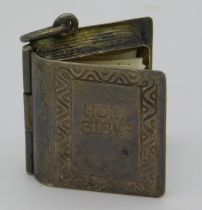 A white metal miniature cased bible charm, 15.4mm