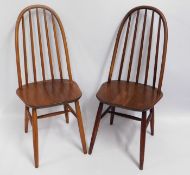 A pair of varnished mid 20thC. Ercol style chairs,