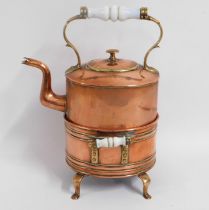 A 19thC. copper kettle with warming stand