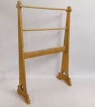 An arts & crafts light oak towel rail, 40in tall