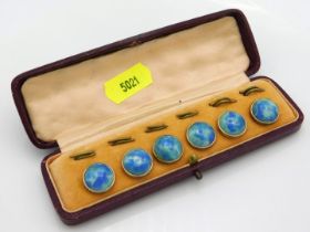 A cased set of Ruskin style gilt mounted buttons