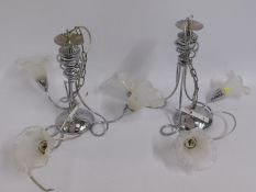 A pair of decorative modern chromed ceiling lamps