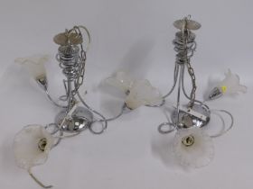 A pair of decorative modern chromed ceiling lamps