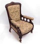 An antique upholstered armchair, 41in high to back
