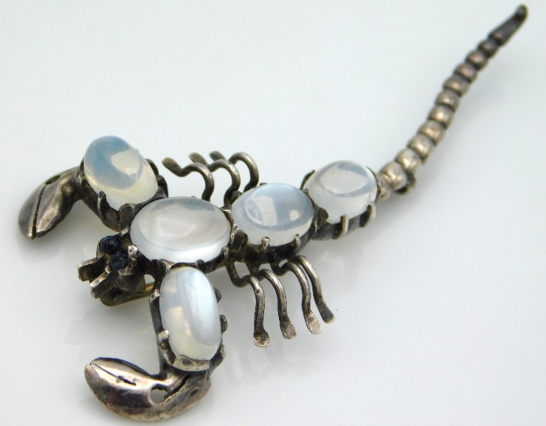 A sterling silver scorpion brooch with moonstone s