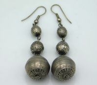 A pair of antique white metal earrings with detail