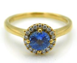 An 18ct gold halo ring set with diamonds & a Ceylo