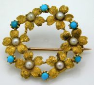 An antique yellow metal floral brooch set with see