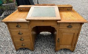 An early 20thC. light oak writing desk, 53.5in wid