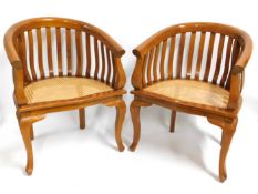 A pair of rose wood arm chairs with cane seats, 31