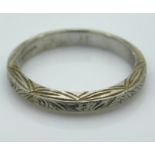 An early 20thC. platinum band with carved decor, 4