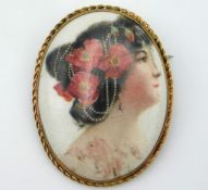 A 9ct gold mounted porcelain brooch depicting youn