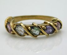 A 9ct gold ring set with topaz, quartz, peridot, a