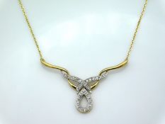 A 9ct gold diamond set necklace, 16in long, drop a
