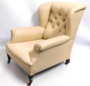 A 19thC. upholstered wing back armchair, 36.125in