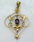 A yellow metal pendant set with amethyst, tests electronically as 9ct gold, 26mm wide with 40mm drop