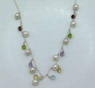 A fine 20in long silver necklace set with south sea pearls, peridot, garnet, amethyst, citrine & top