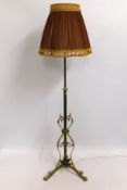 A decorative brass adjustable lamp with silk shade