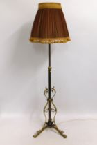 A decorative brass adjustable lamp with silk shade