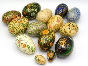 Fourteen hand decorated wooden eggs