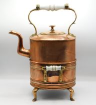 A 19thC. copper kettle with warming stand