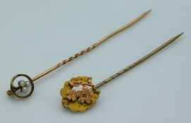 A yellow metal tie pin set with seed pearl, tests