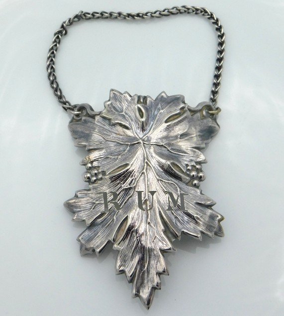 A white metal Rum decanter label in the form of a vine leaf, 10.3g, 75mm drop