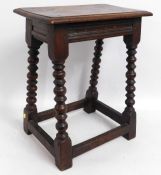An early 20thC. oak stool, 22.75in high