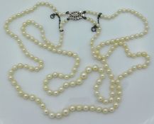 A 20in long double string of pearls with a 9ct whi