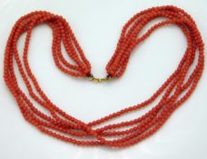 A five strand set of coral beads with 18ct gold cl