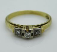 A 14ct gold ring set with three small diamonds, 0.12ct, 2.8g, size M/N