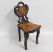 A child's Black Forest style carved musical chair