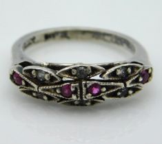 A silver ring set with paste stones & small rubies