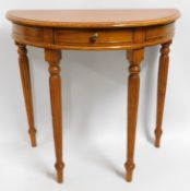 A rosewood 'D' shaped hall table with drawer, 31.5