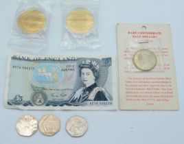 An English five pound bank note, three 50p pieces,
