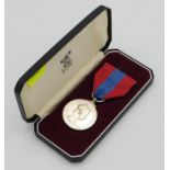 A cased Royal Mint twenty five year service medal