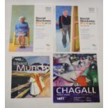 Four unframed exhibition posters