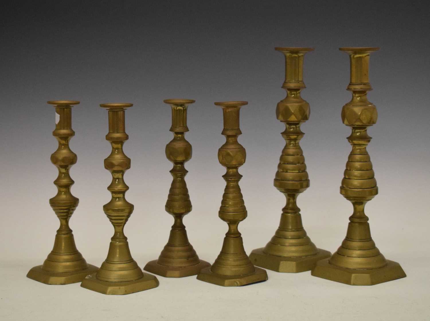 Three pairs of brass candlesticks