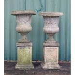 Pair of composite stone garden pedestal planters on pedestal bases