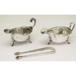 Two George V silver sauce boats and a pair of silver sugar tongs