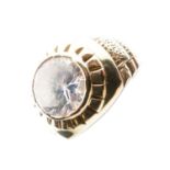 Yellow metal ring set large clear stone