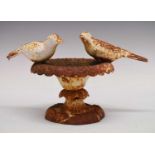 Cast iron bird bath decorated with a pair of doves