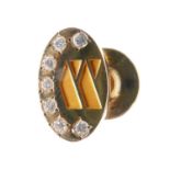 Yellow metal (14K) lapel badge, set seven diamonds