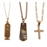Three gold and yellow metal pendants with chains