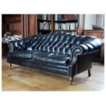 Modern deep-buttoned black leatherette lounge suite