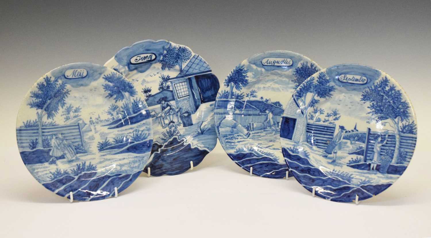 Four Continental faience calendar plates