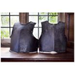 Two 17th Century iron breastplates,